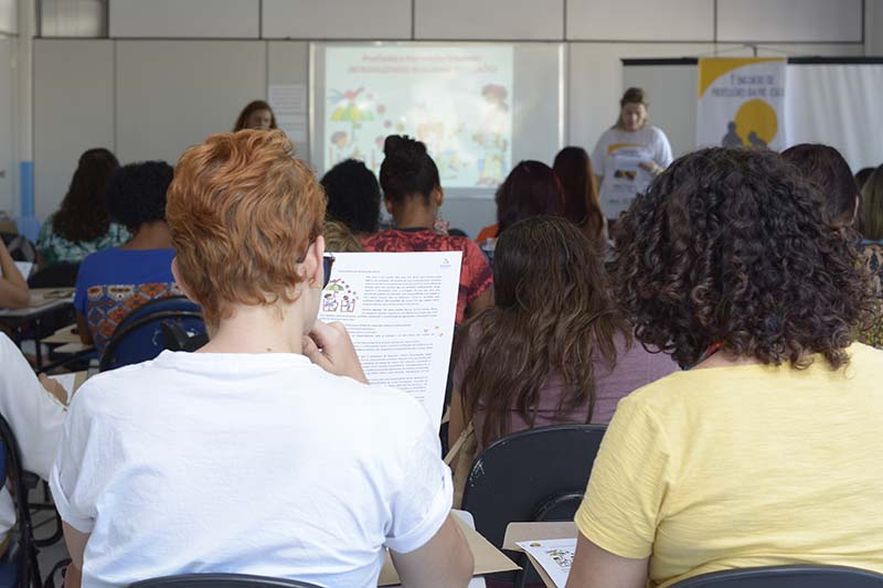 pessoas sentadas dentro de uma sala de aula